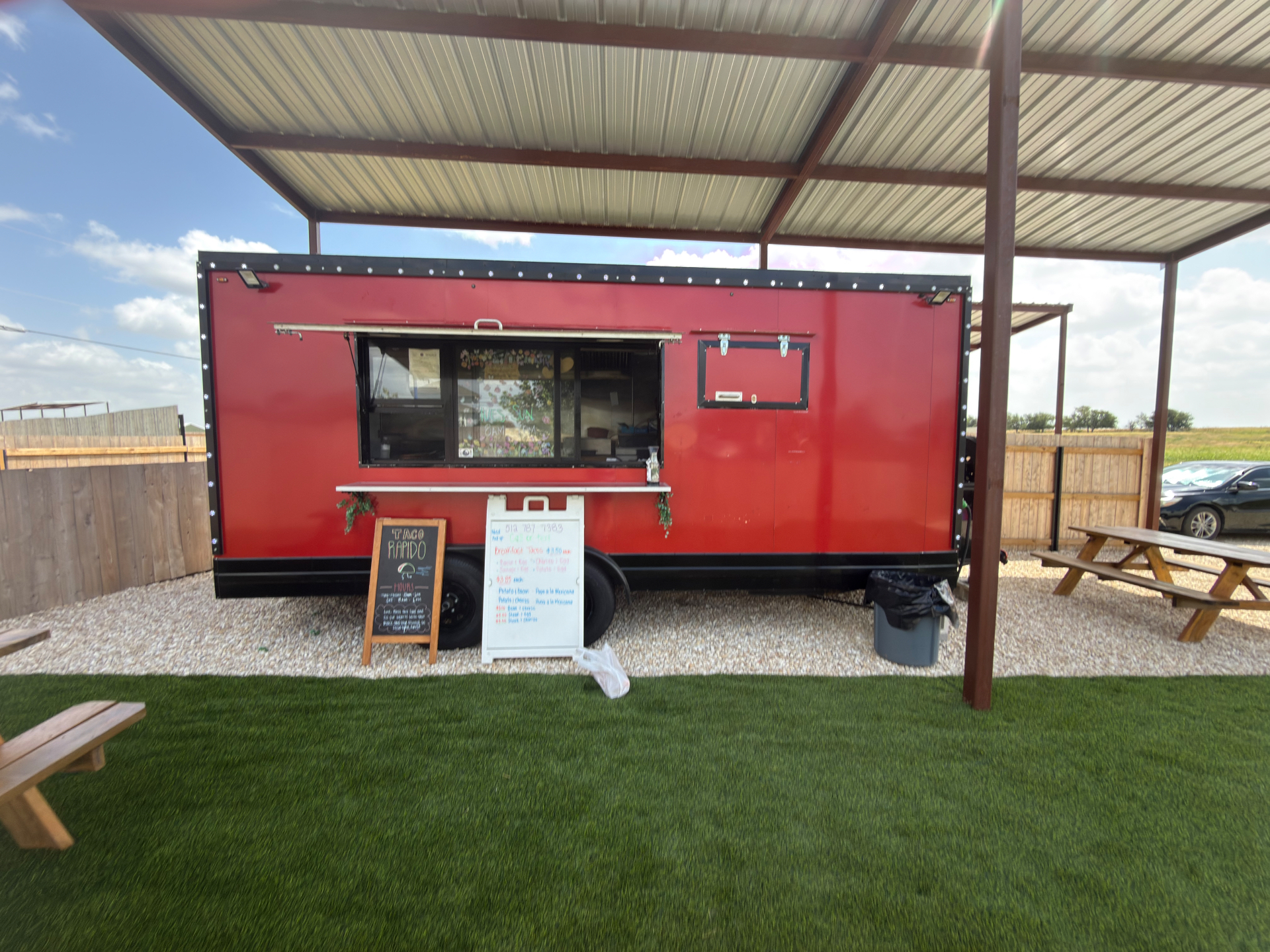 The red Taco Rapido GTX food truck parked under a covered patio in Georgetown, Texas